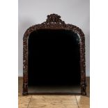 A richly sculpted oak wooden mirror, 19th C.