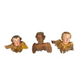 Three Flemish wooden angel heads, two of them with polychrome design, 17/18th C.