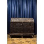 A large French wooden 'bahut' trunk with leather upholstery and wrought iron fittings on a wooden ba