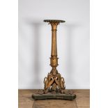 An imposing polychrome and gilt metal candlestick on a wooden base, 20th C.