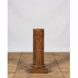 A wooden pedestal in the shape of a fluted column, 19th C.