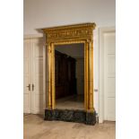 An impressive French Empire-style gilt wooden mirror on faux marble-painted stand, 19th C