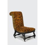 An ebonised wooden 'leopard design' chair on wheels, 19/20th C.