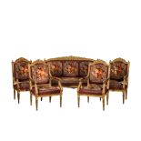 A neoclassical gilt wooden salon set comprising a sofa and four armchairs, 20th C.