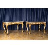 A pair of Italian patinated and gilt wooden wall consoles with marble top, 18th C.