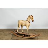 A wooden rocking horse covered with natural fur, early 20th C.