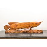 A large Indonesian wood sculpture of a fish, 1st half 20th C.