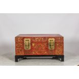 A Chinese red lacquered bronze-mounted travel trunk on foot, 20th C
