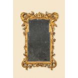 A French finely carved gilt wooden Regence mirror, 18th C.