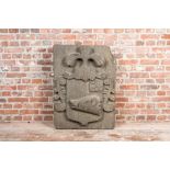 A carved stone relief with a coat of arms with the head of a wild boar, 19th C.