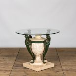 A bronze patinated metal and composite garden table with glass top, 20th C.