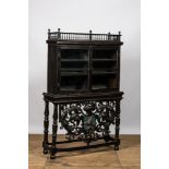 A Spanish ebonised wooden display cabinet on richly carved armorial stand, 19th C.