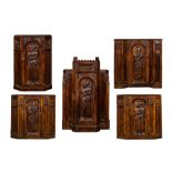 Five richly carved Gothic Revival oak single-door cupboards 19/20th C.