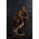 A large walnut sculpture of a resting man, 18/19th C.