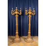 A pair of large patinated wooden and cast iron nine-light candelabra, ca. 1900