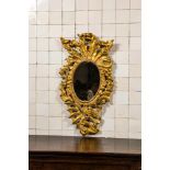 A richly carved gilt wooden Rococo mirror, 18th C.