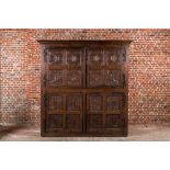 A rare large Flemish oak four-door cupboard with carved X-panels and wrought iron mounts, 1st half 1