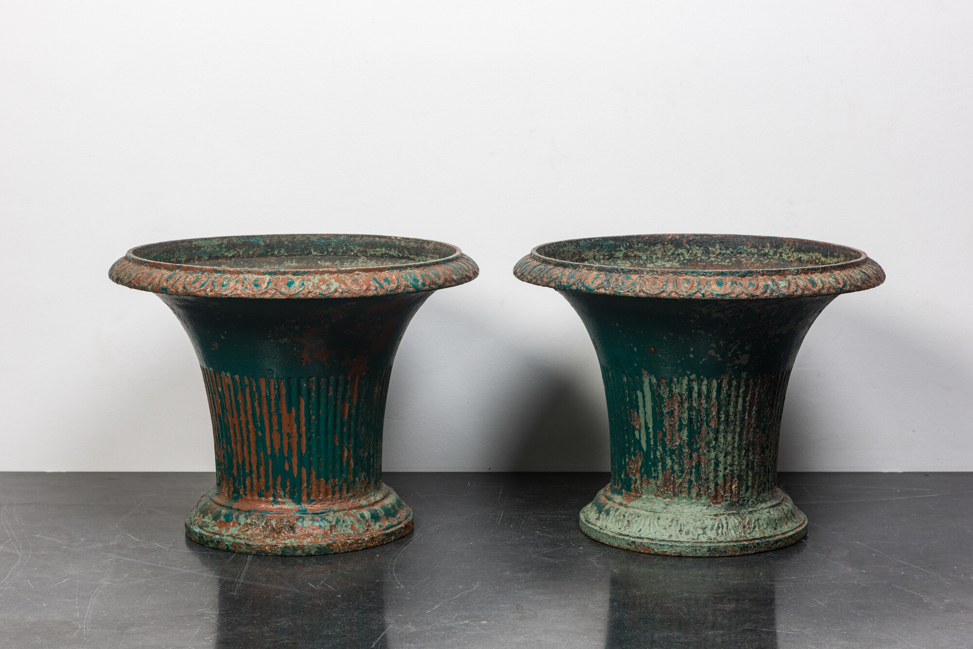 A pair of green-painted cast iron jardinires, 19th C.