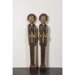 A pair of polychrome wooden pillars or atlants with boys' heads, 19th C.
