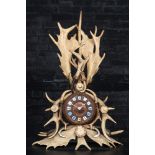 A Black Forest 'wild boar teeth and antlers' mantle clock, 19th C.