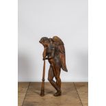 A large wooden relief with an angel resting on his trumpet, 18th C.