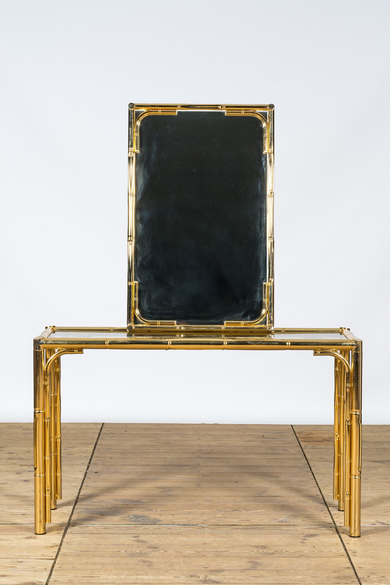 A brass Hollywood Regency style console with matching mirror, Italy, 20th C.