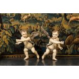 A pair of large polychrome wooden winged cherubs, 19th C.