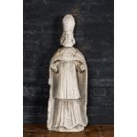 A large limestone sculpture of a standing bishop, 18th C.