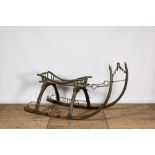 A wrought iron-mounted green-painted wooden sleigh, 19th C.