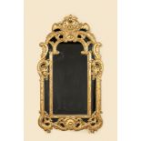 A French carved and gilt wooden mirror, 19th C.