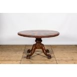 A round rosewood table on a mahogany base, 19/20th C.