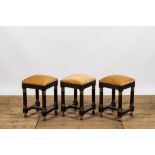 Three square black painted brass mounted wooden stools, 20th C.