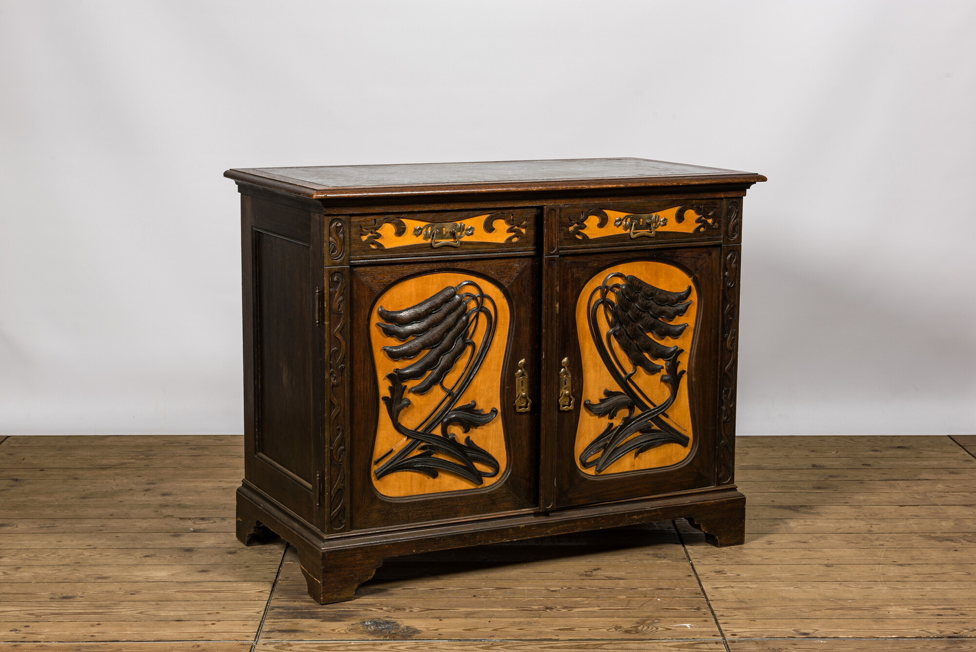 A partly veneered oak wooden Art Nouveau-style linen cupboard with marble top, 20th C. - Image 2 of 4