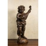 A large patinated wooden putto playing the lute, 18th C.