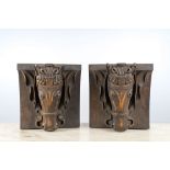 A pair of patinated wooden wall consoles with a horse's head, 20th C.