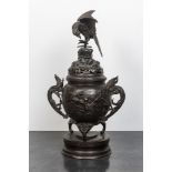 A large Japanese patinated bronze koro on stand with birds, dragons and blossoming branches, Meiji,