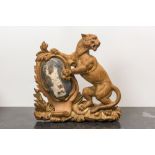 A wooden relief with a tiger holding a shield, 19th C.