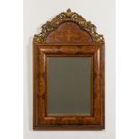 A wooden marquetry mirror with gilt wooden ornamental crown, 19th C.