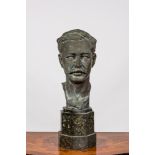 A bronze male bust on a marble base, 20th C.