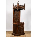 A large Gothic Revival oak hooded throne chair with dragons and frogs, 19th C.