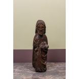 A Spanish walnut figure of John the Baptist, mid 15th C.