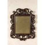 A Baroque-style walnut mirror, 19th C.