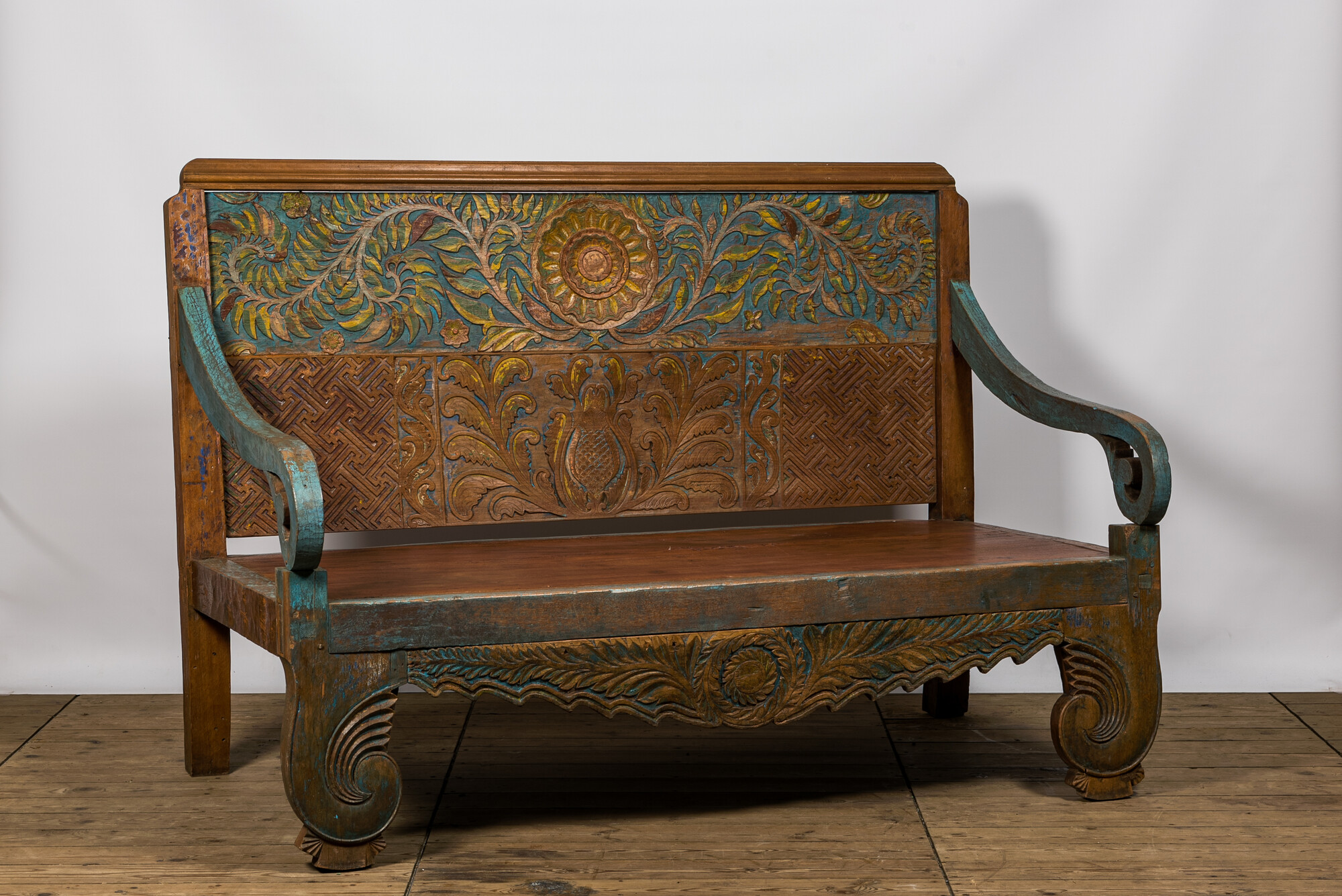 A large Indian polychrome wooden couch with floral design, 20th C. - Image 2 of 4