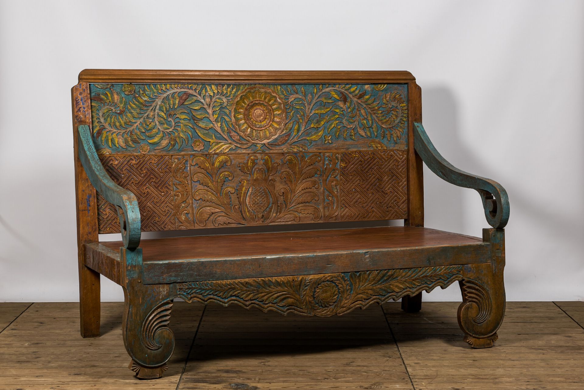 A large Indian polychrome wooden couch with floral design, 20th C. - Image 2 of 4