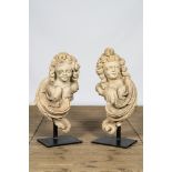 A pair of French limestone angel busts on a metal base, 18th C.