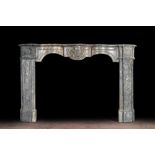 A French Louis XV style gray marble fireplace with mascaron, 19th C.