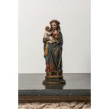 A polychromed wooden Madonna and Child on stand, 17th C.