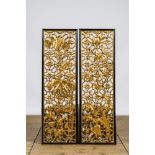 A pair of Chinese openworked and gilt wooden panels with floral design, 19/20th C