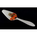 RHODANTHE PATTERN CAKE SLICE, in honey glaze with moulded handle, 19cms long (glaze chip, unmarked)