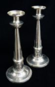 PAIR CONTINENTAL WHITE METAL EGYPTIAN REVIVAL CANDLESTICKS, tapering cylindrical columns with